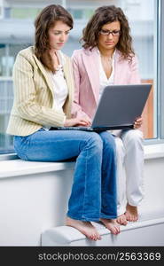 Young creative businesswomen team working on laptop computer at office.