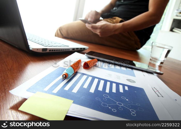 Young creative designer man working at office and social network media and graph chart diagram as concept