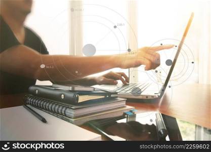 Young creative designer man working at office with computer laptop as concept with social media diagram
