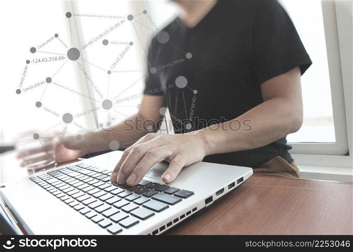 Young creative designer man working at office with computer laptop with social network diagram concept