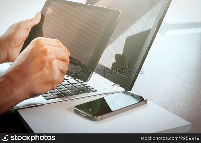 Young creative designer man working with stylus pen and digital tablet at office and social network media diagram as concept