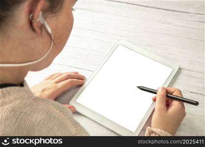 Young creative digital artist working with graphic tablet with pen in hands of young woman isolated white background for copy space. top view space for text. Young creative digital artist working with graphic tablet with pen in hands of young woman isolated white background for copy space. top view