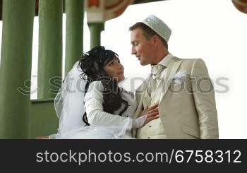 Young Crimean Tatar couple on the steps of the Big Khan Mosque in Bakhchisaray Palace. Bakhchisaray, Crimea, Ukraine