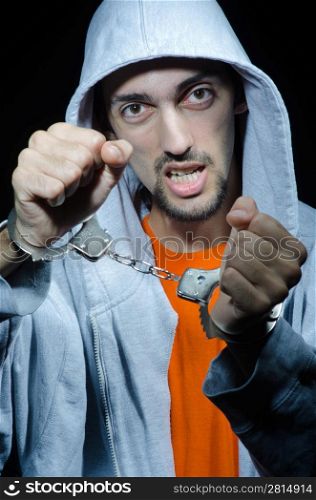Young criminal with handcuffs