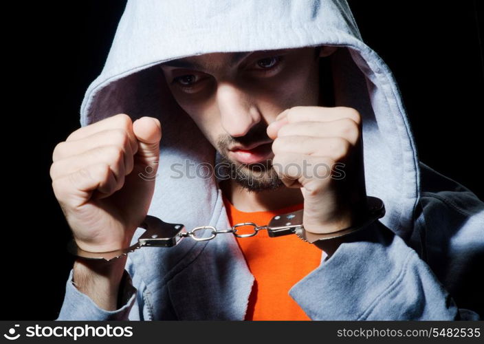 Young criminal with handcuffs