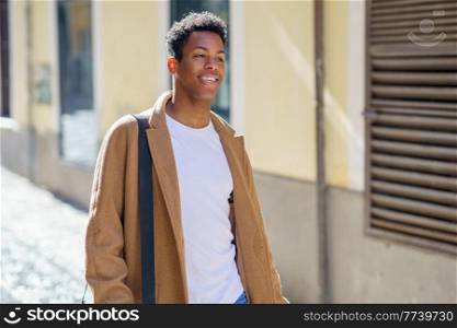 Young Cuban man standing in the street. Student in urban background.. Young Cuban man standing in the street.
