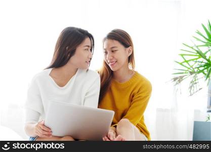 Young cute asia lesbian couple using laptop with happiness at home, lgbt, homosexual, lesbian couple lifestyle