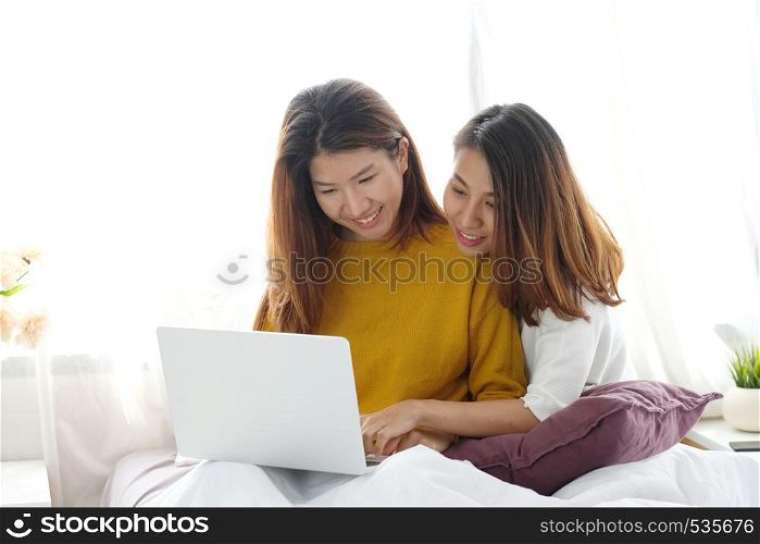 Young cute asian woman lesbian couple using laptop computer with happiness at home, lgbt, homosexual, lesbian couple, diversity lifestyle