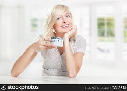 Young cute blonde drinking coffee