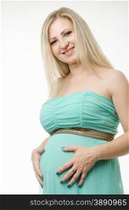 Young cute pregnant girl twenty five European-type. Portrait of a pregnant young girl hugging belly