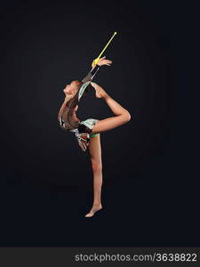 Young cute woman in gymnast suit show athletic skill on black background