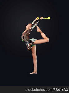 Young cute woman in gymnast suit show athletic skill on black background