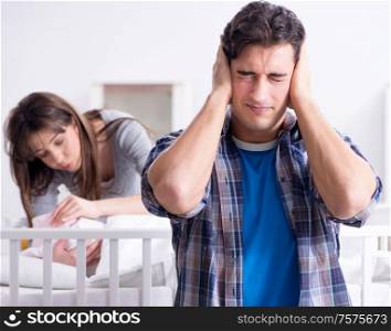Young dad cannot stand baby crying. The young dad cannot stand baby crying