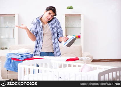 Young dad looking after newborn baby