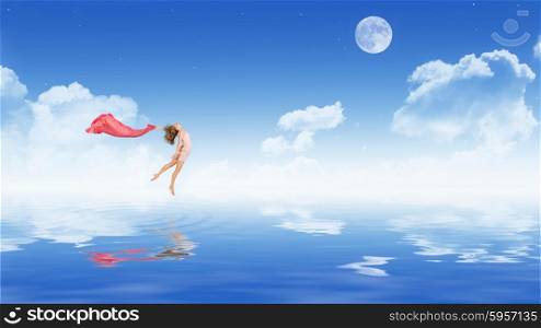 Young dancing girl in dress on water surface