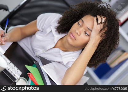 young depressed businesswoman sitting at office desk