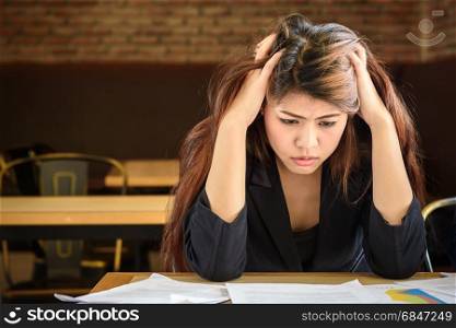 Young depressed stressed frustrated asian businesswoman working at office desk. Young depressed stressed asian businesswoman working at office d