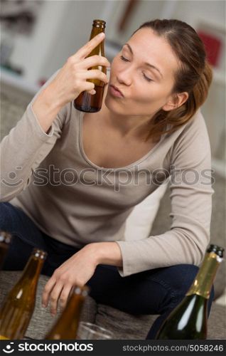 young depressed woman drinking alcohol