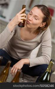 young depressed woman drinking alcohol