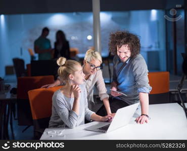 young designers working on a new project in the night startup office using modern technology