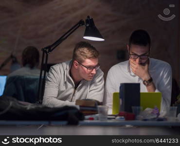 young designers working on a new project in the night startup office using modern technology