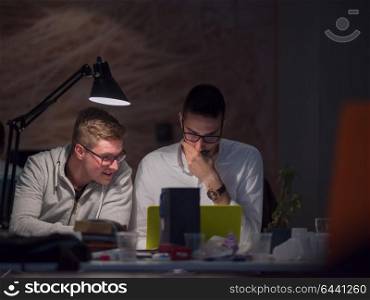 young designers working on a new project in the night startup office using modern technology