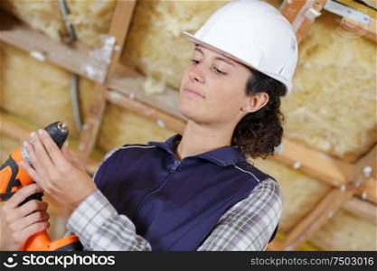 young determinated woman using drill