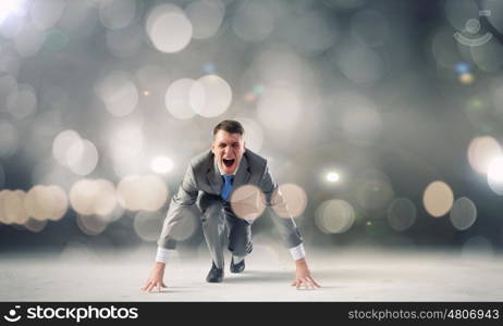 Young determined businessman standing in start position