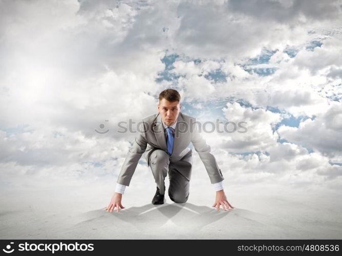 Young determined businessman standing in start position