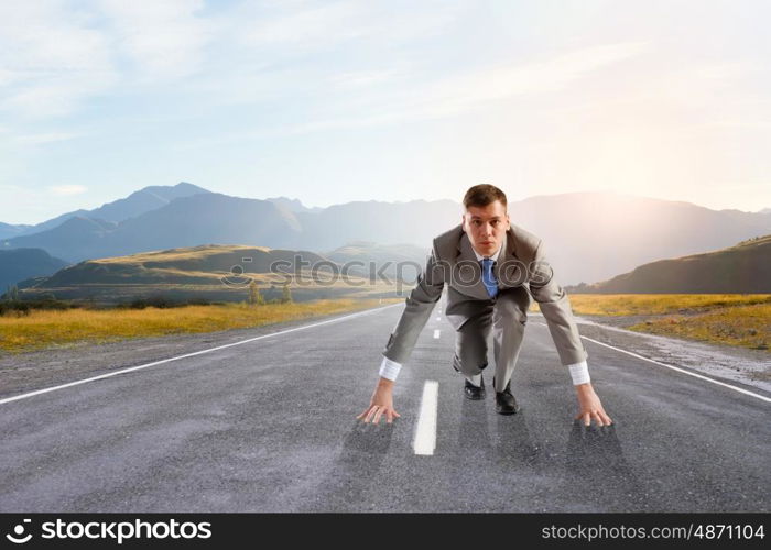 Young determined businessman standing in start position