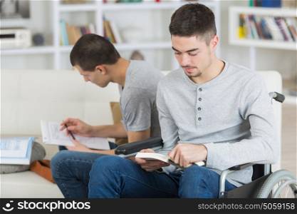 young disabled boy and his friend studying together