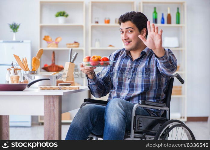 Young disabled husband preparing food salad