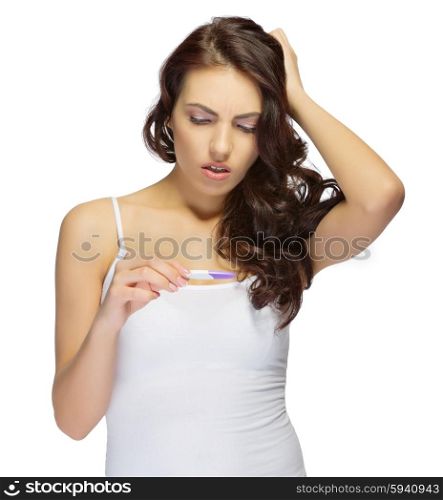 Young displeased girl with pregnancy test isolated