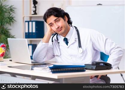 Young doctor cardiologist working in the clinic 