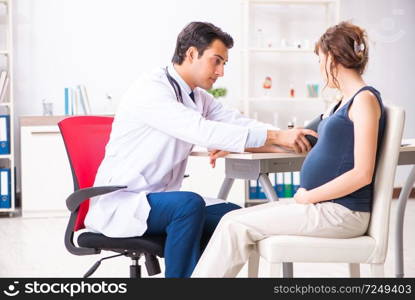 Young doctor checking pregnant woman&rsquo;s blood pressure. The young doctor checking pregnant woman&rsquo;s blood pressure