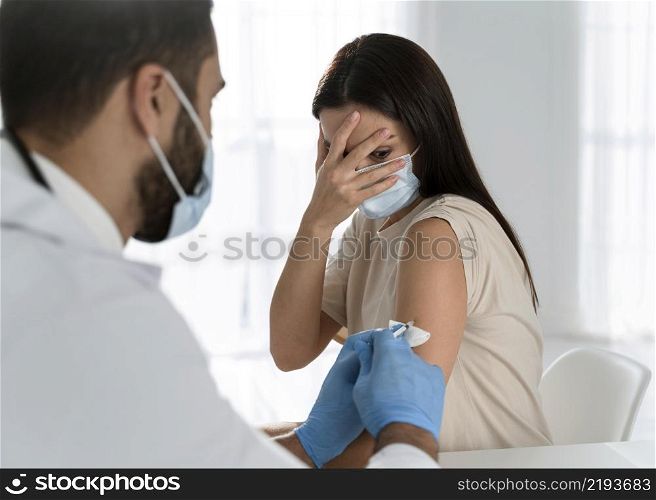 young doctor doing vaccine frightened patient