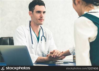 Young doctor examining female patient in hospital office. Medical healthcare and doctor staff service concept.. Young doctor examining patient in hospital office.