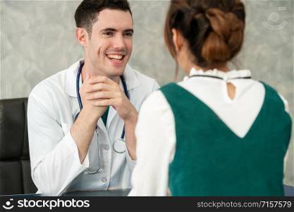 Young doctor examining female patient in hospital office. Medical healthcare and doctor staff service concept.