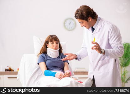 Young doctor examining injured patient 