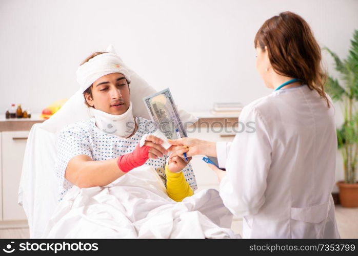 Young doctor examining injured patient 