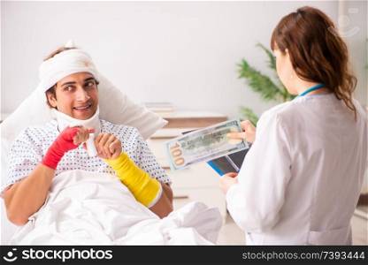Young doctor examining injured patient 