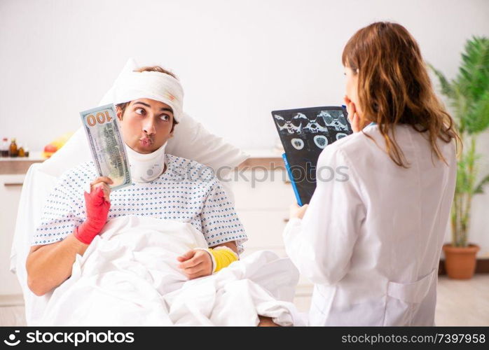 Young doctor examining injured patient 