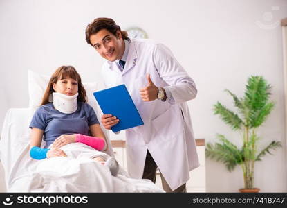 Young doctor examining injured patient 