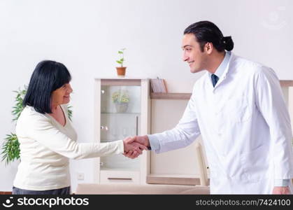 Young doctor examining senior old woman