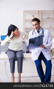 Young doctor examining senior old woman