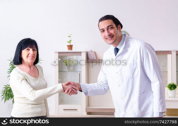 Young doctor examining senior old woman