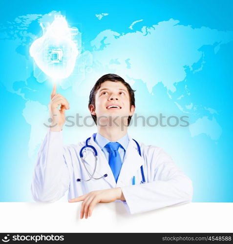 Young doctor. Image of handsome doctor holding white blank banner