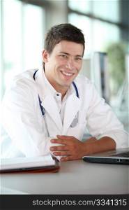 Young doctor in front of laptop computer