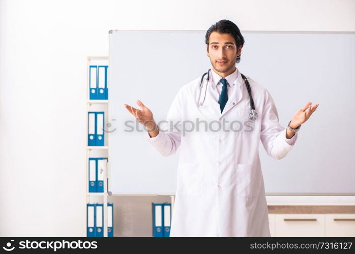 Young doctor in front of whiteboard 