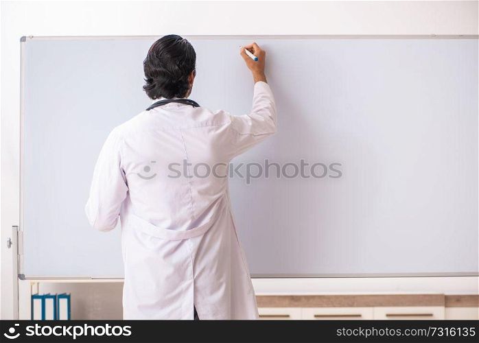 Young doctor in front of whiteboard 